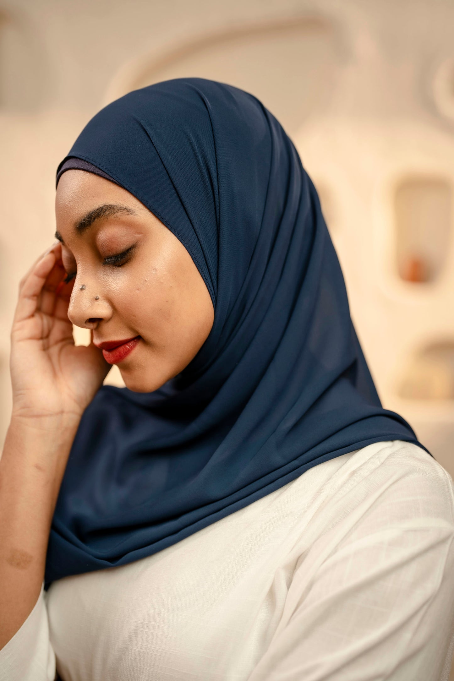 Woman wearing a navy hijab with a blurred background