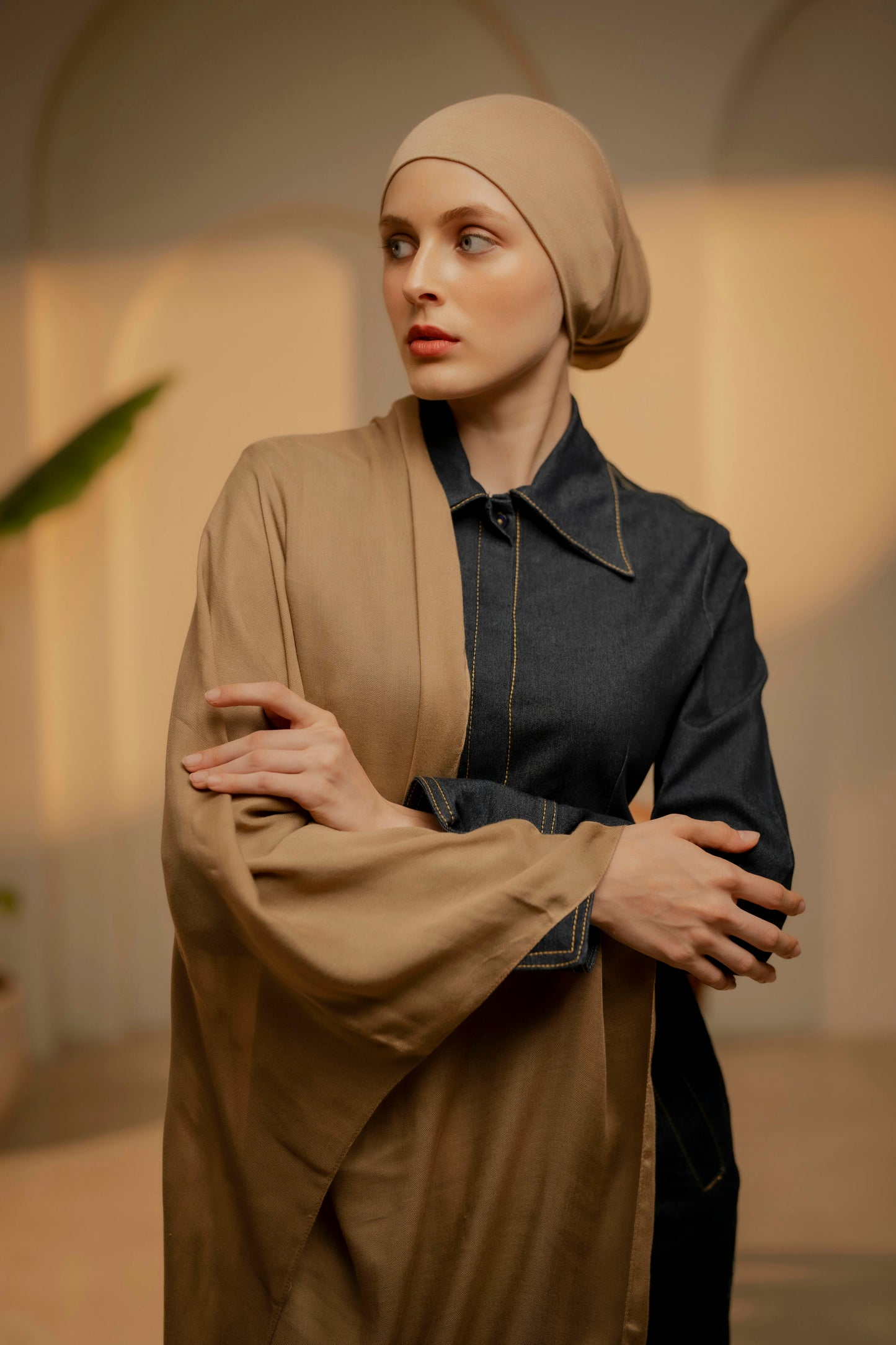 Woman wearing a beige headscarf and coat in an indoor setting - caramel