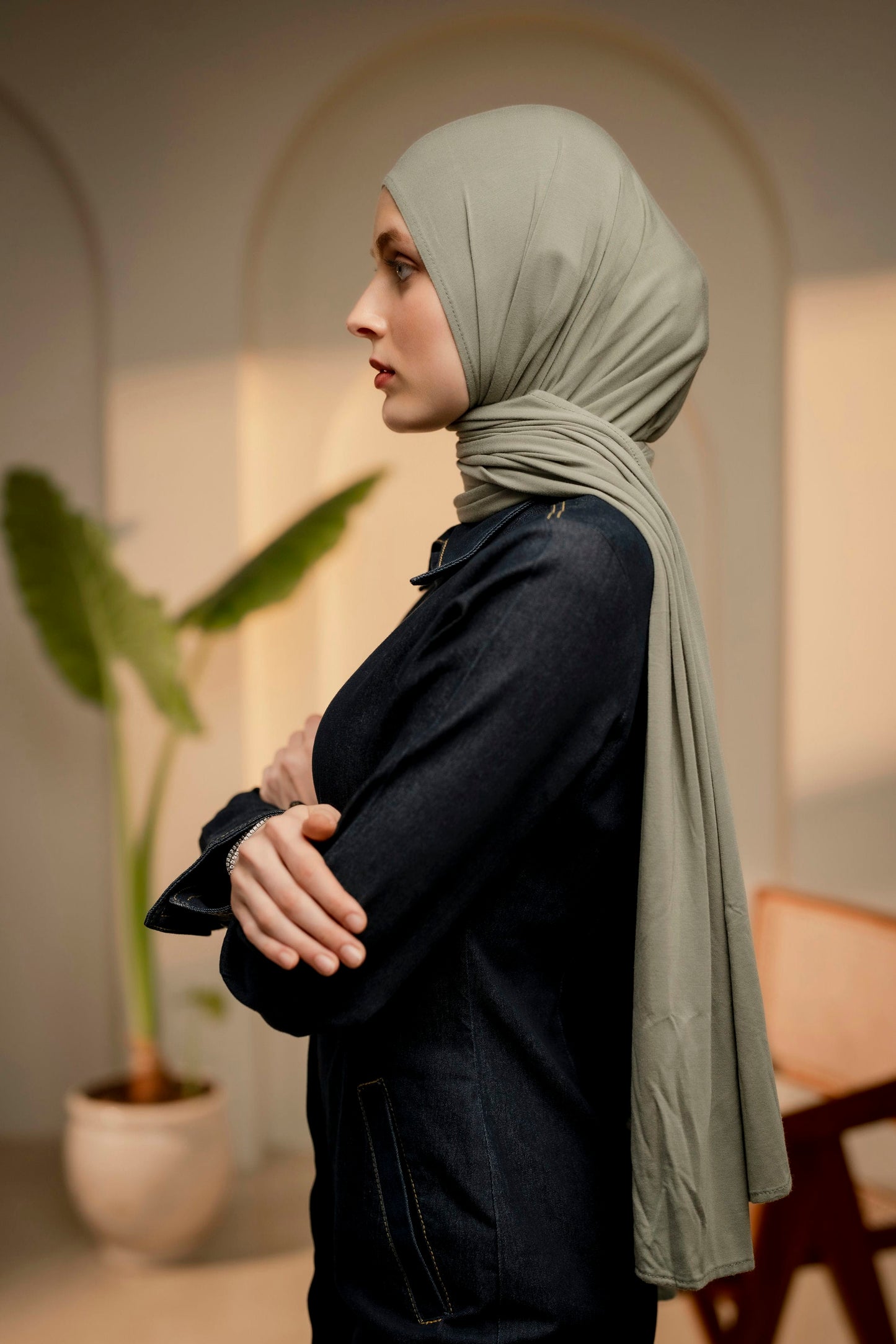 Side view of a woman wearing a sea green hijab