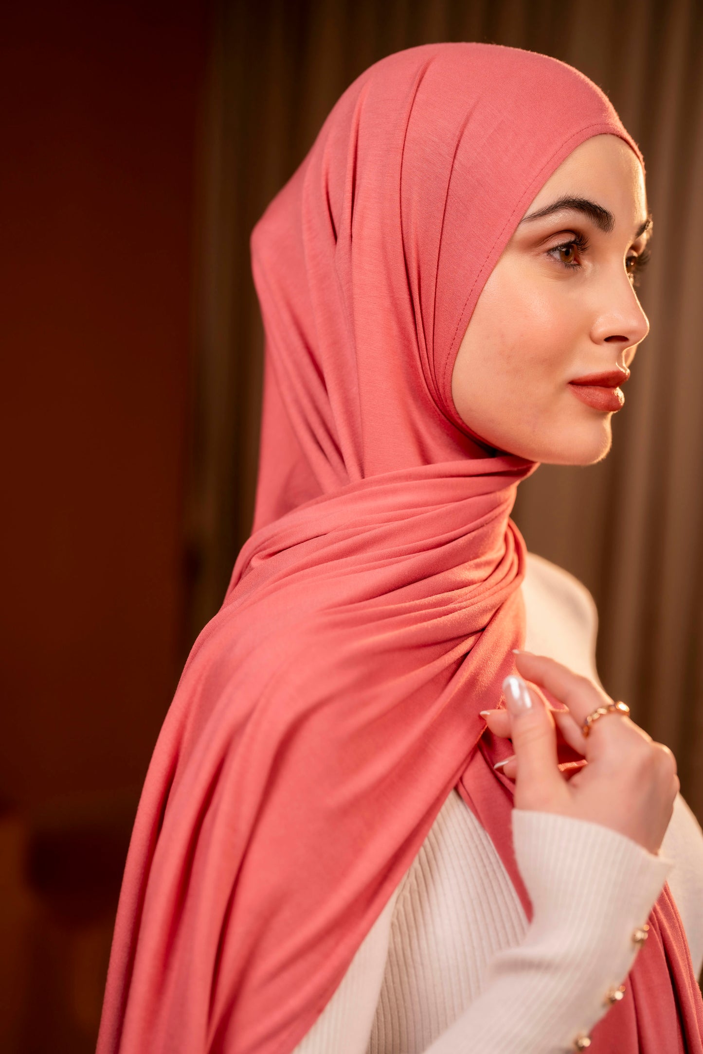 Woman wearing a pink hijab with a blurred background, get yours delivered free