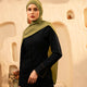 Woman wearing a green hijab and dark outfit against an abstract beige background - Olive Green