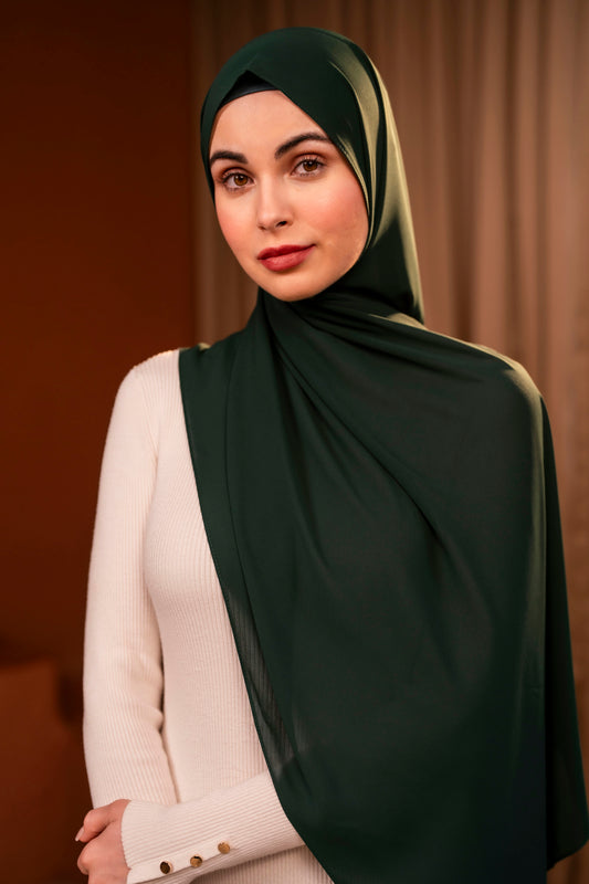 Woman wearing a dark green hijab against a dark background - Forest Green