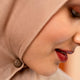 Close-up of a person wearing a brown hijab magnet with a blurred background