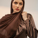 Woman wearing a brown hijab and matching outfit against a plain background - coffee brown