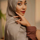 Woman wearing a beige hijab with a blurred background
