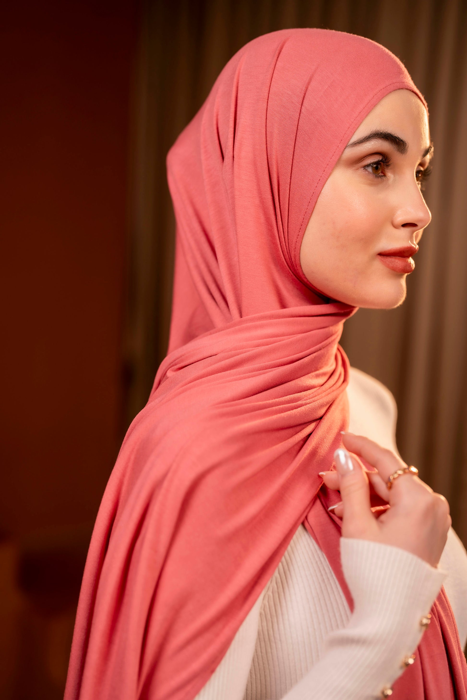 Woman wearing a pink hijab with a blurred background, get yours delivered free